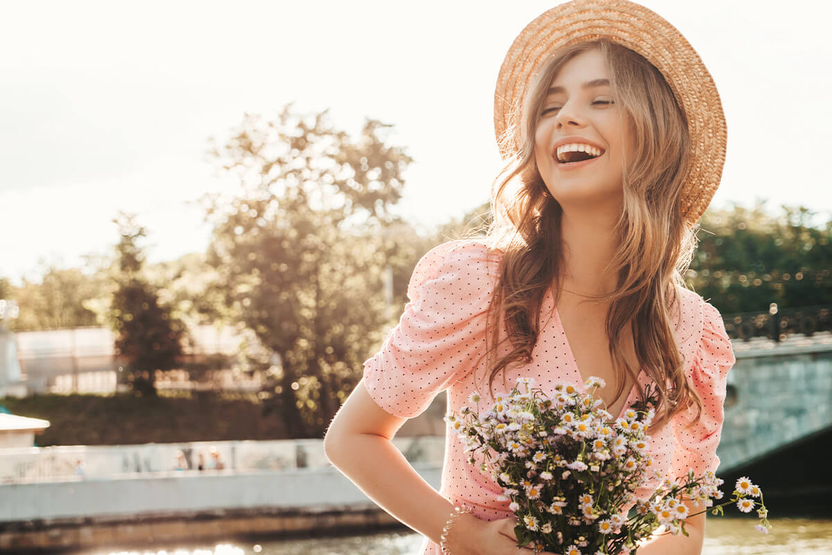 Woman smiling while holding flowers