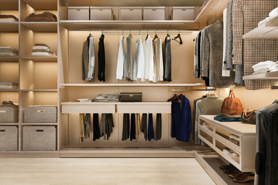 Walk in closet with high end luxury clothing hanging on rack